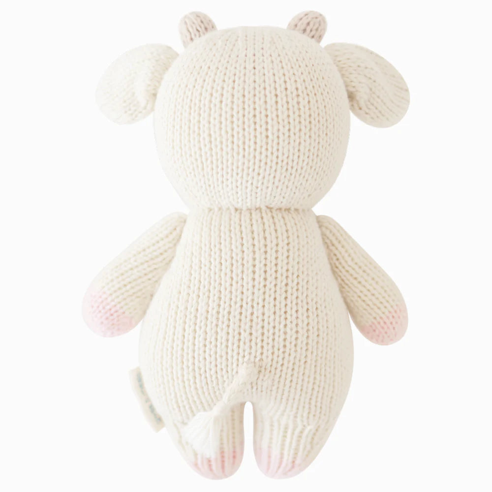 Back view of Cuddle+Kind baby cow hand knit stuffed toy showing rounded ears, tail and knit texture