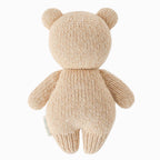 Back view of Cuddle+Kind baby honey bear hand knit stuffed toy showing rounded ears and knit texture