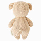 Back view of Cuddle+Kind baby puppy hand knit stuffed toy showing tail and textured knit fabric