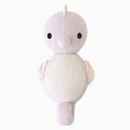 Close up of Cuddle+Kind baby seahorse showing textured hand knit fabric and stitched details