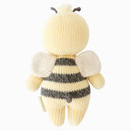 Back view of Cuddle+Kind baby bee hand knit stuffed toy showing small wings and knit texture