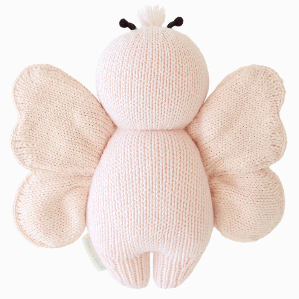 Back view of Cuddle+Kind baby butterfly hand knit stuffed toy showing layered wings and knit texture