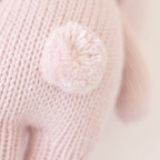Close up of Cuddle+Kind baby bunny plush toy showing textured knit fabric and stitching details