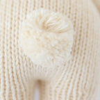 Close up of Cuddle+Kind baby bunny plush toy showing textured knit fabric and stitching details