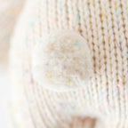 Close up detail of Cuddle+Kind baby bunny confetti knit fabric showing textured stitching and speckled cotton