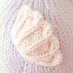 Close up of Cuddle+Kind baby seahorse showing textured hand knit fabric and stitched details