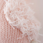 Close up of Cuddle+Kind baby flamingo showing textured hand knit fabric and stitching details