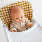 close up of mustard gingham highchair for dolls made by tiny harlow with a baby boy doll