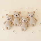 Cuddle+Kind hand knit baby animal plush toy collection arranged together in soft neutral nursery decor