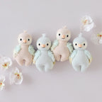 Cuddle+Kind hand knit baby animal plush toy collection displayed together in soft pastel colours