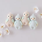 Cuddle+Kind baby parrot knit plush toys styled together with matching hand knit animal friends