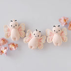 Cuddle+Kind baby butterfly plush toy displayed with coordinating hand knit animal friends