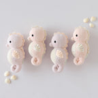 Cuddle+Kind hand knit baby animal plush toy collection displayed together in soft pastel nursery decor