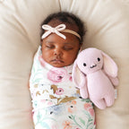 Baby cuddling Cuddle+Kind baby bunny soft knit plush toy during playtime