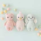 Cuddle+Kind baby gosling knit plush toy styled with coordinating hand knit baby animal friends in pastel nursery setting