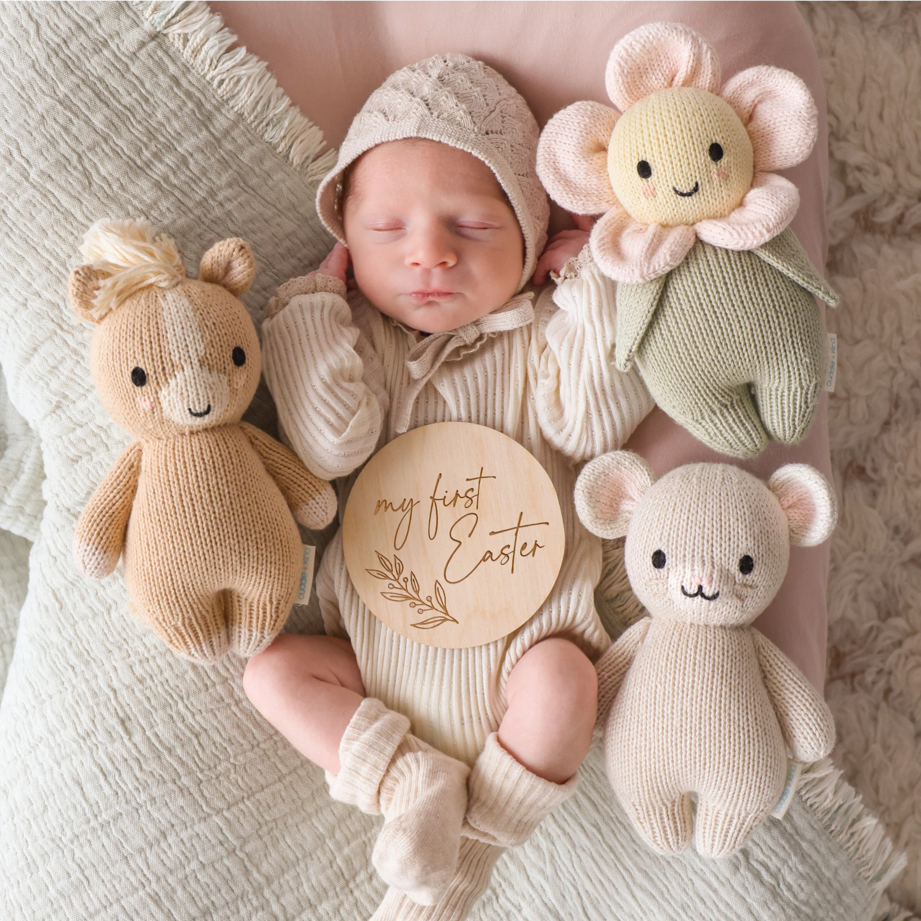 Cuddle+Kind baby animal collection of hand knit plush toys arranged together in nursery setting. including baby pony, baby mouse and baby daisy