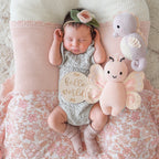Baby cuddling Cuddle+Kind baby butterfly soft knit plush toy during playtime