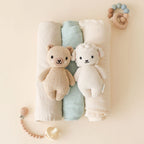 Cuddle+Kind hand knit baby animal plush toy collection arranged together in soft neutral nursery decor