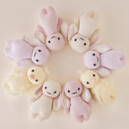 Cuddle+Kind baby bunny knit plush toy styled with matching hand knit baby animals in neutral nursery setting