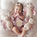 Baby cuddling Cuddle+Kind baby butterfly soft knit plush toy during playtime