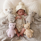 Baby cuddling Cuddle+Kind baby giraffe soft knit plush toy during playtime