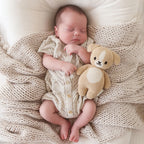 Baby cuddling Cuddle+Kind baby puppy soft knit plush toy during playtime