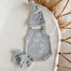 He’s Here newborn knit romper bundle by Blossom and Pear with matching booties and pom pom beanie