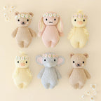 Cuddle+Kind baby honey bear knit plush toy styled with matching hand knit baby animals in nursery setting
