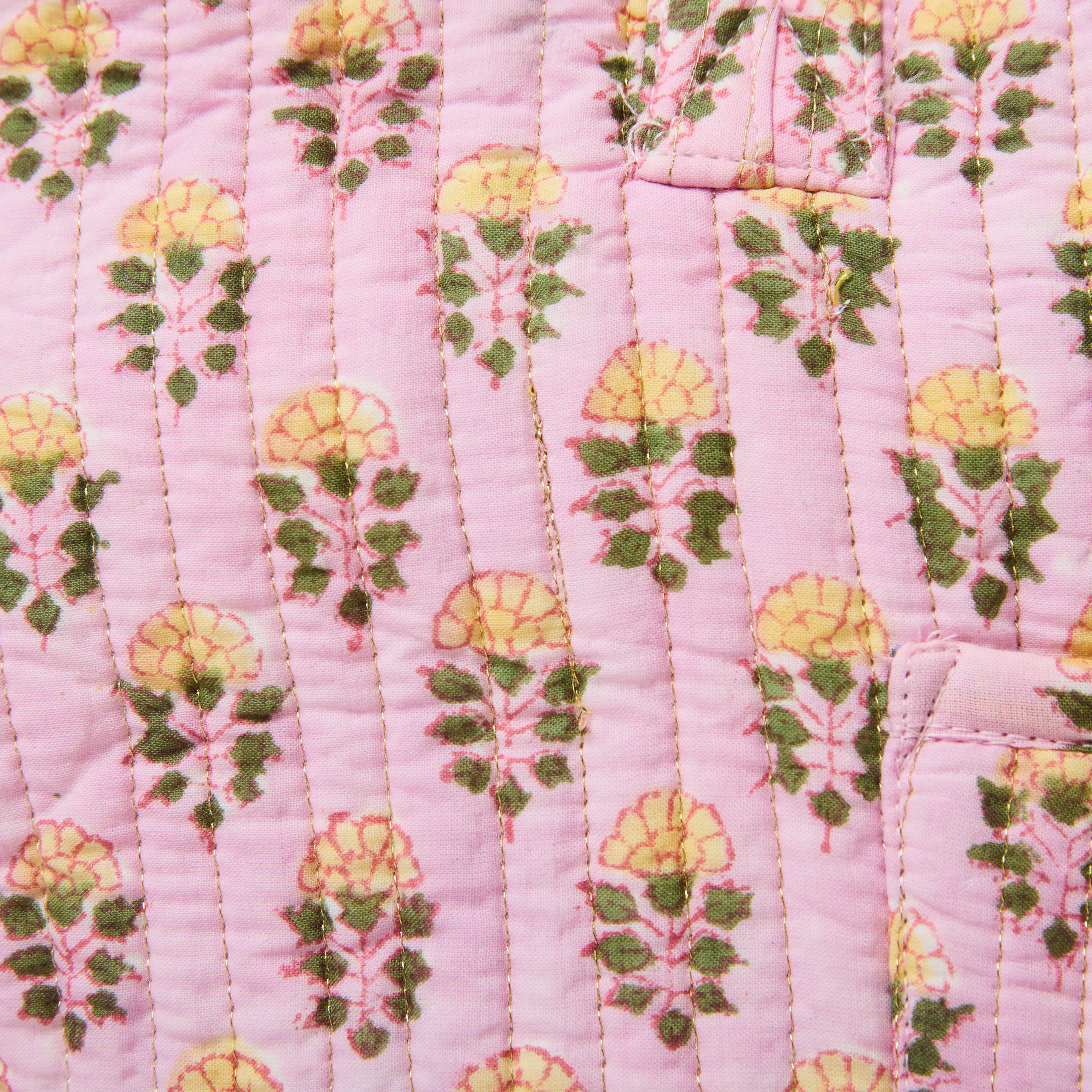 quilted cotton travel bag in pink with small floral pattern