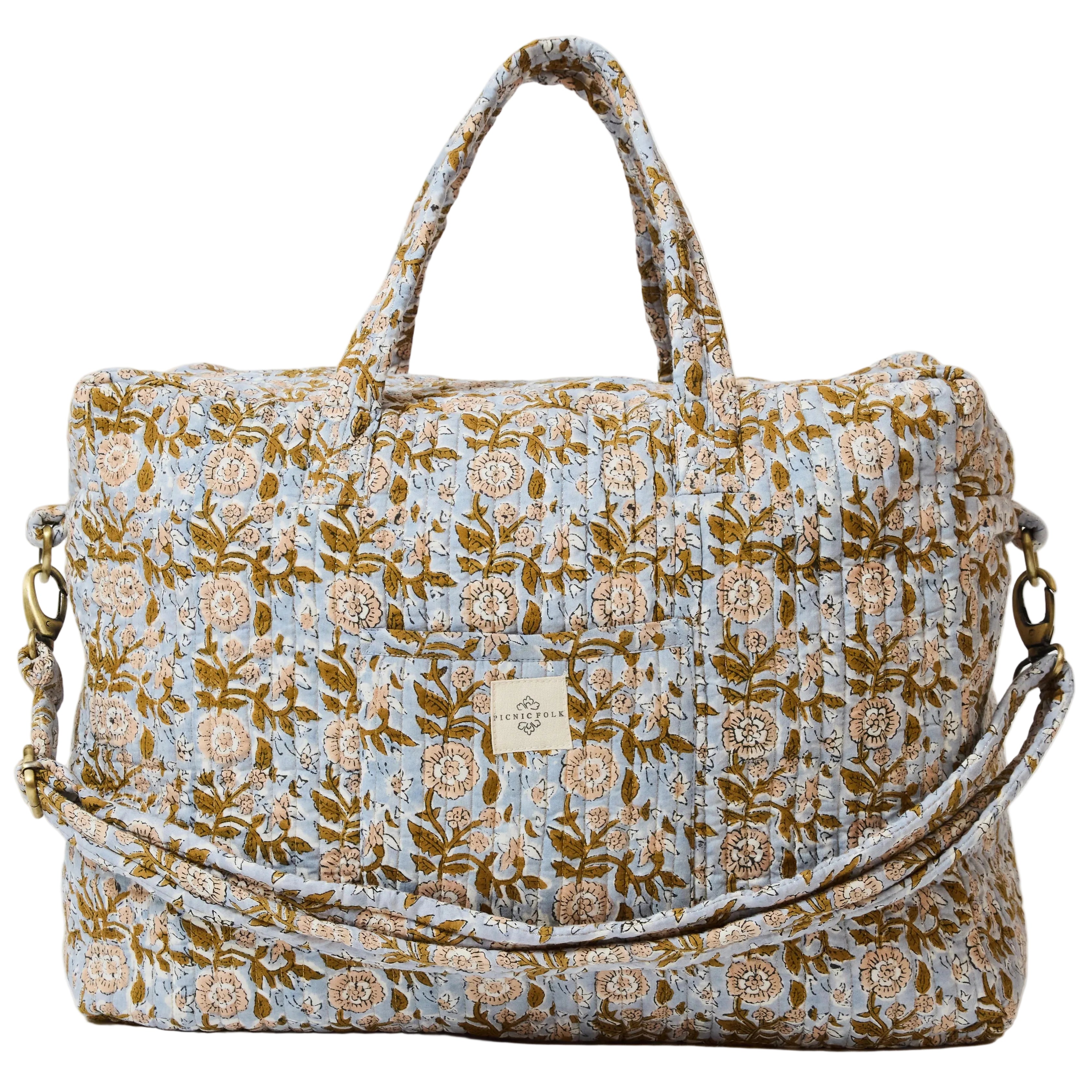 quilted floral overnight bag with carry handles and shoulder strap