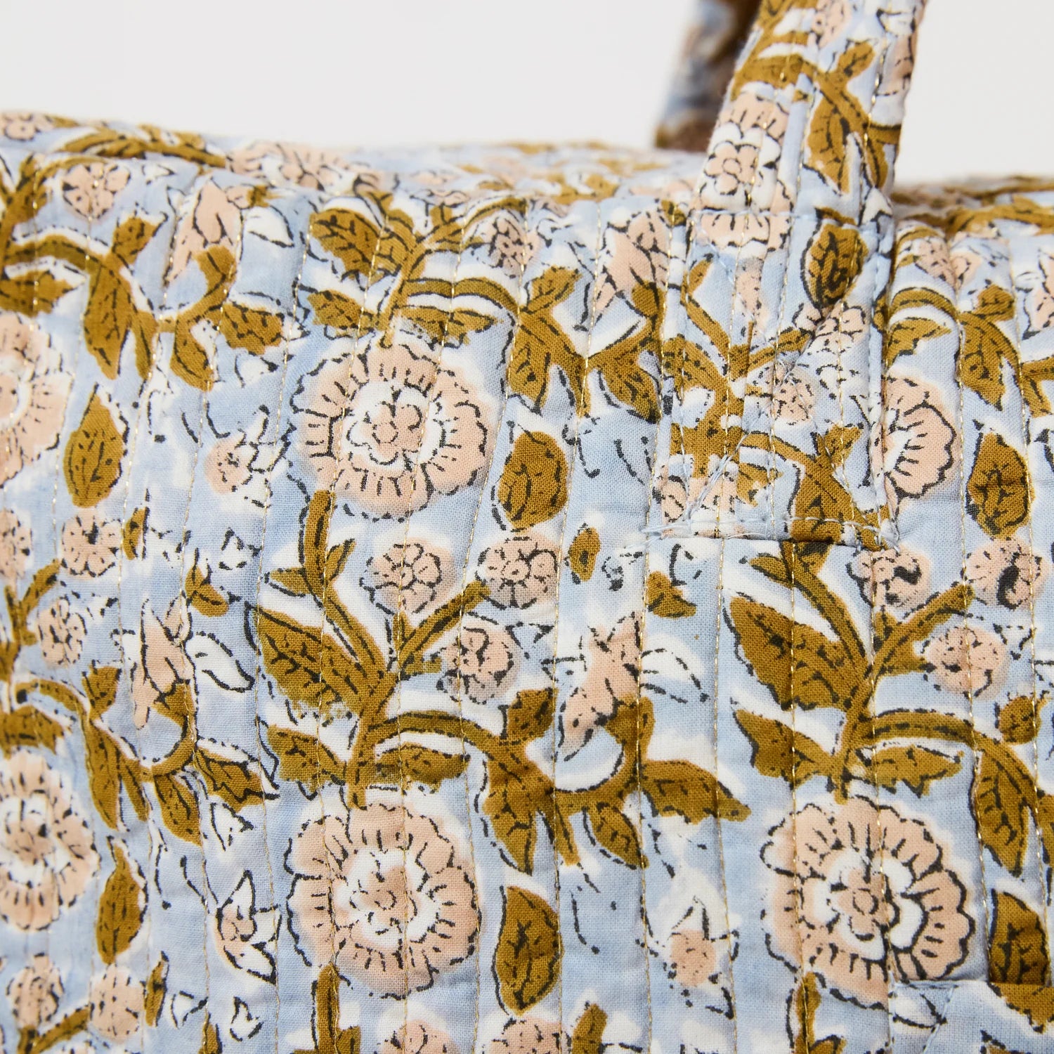 floral quilted bag with gold hardware and zip closure