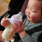 baby drinking milk from a b.box anti-colic baby bottle during feeding