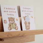 milestone cards by lively living to track babies age and milestones. great for photos and theme is cuddly bear. card pictured reads i babbled and smiled today, i played peek a boo today