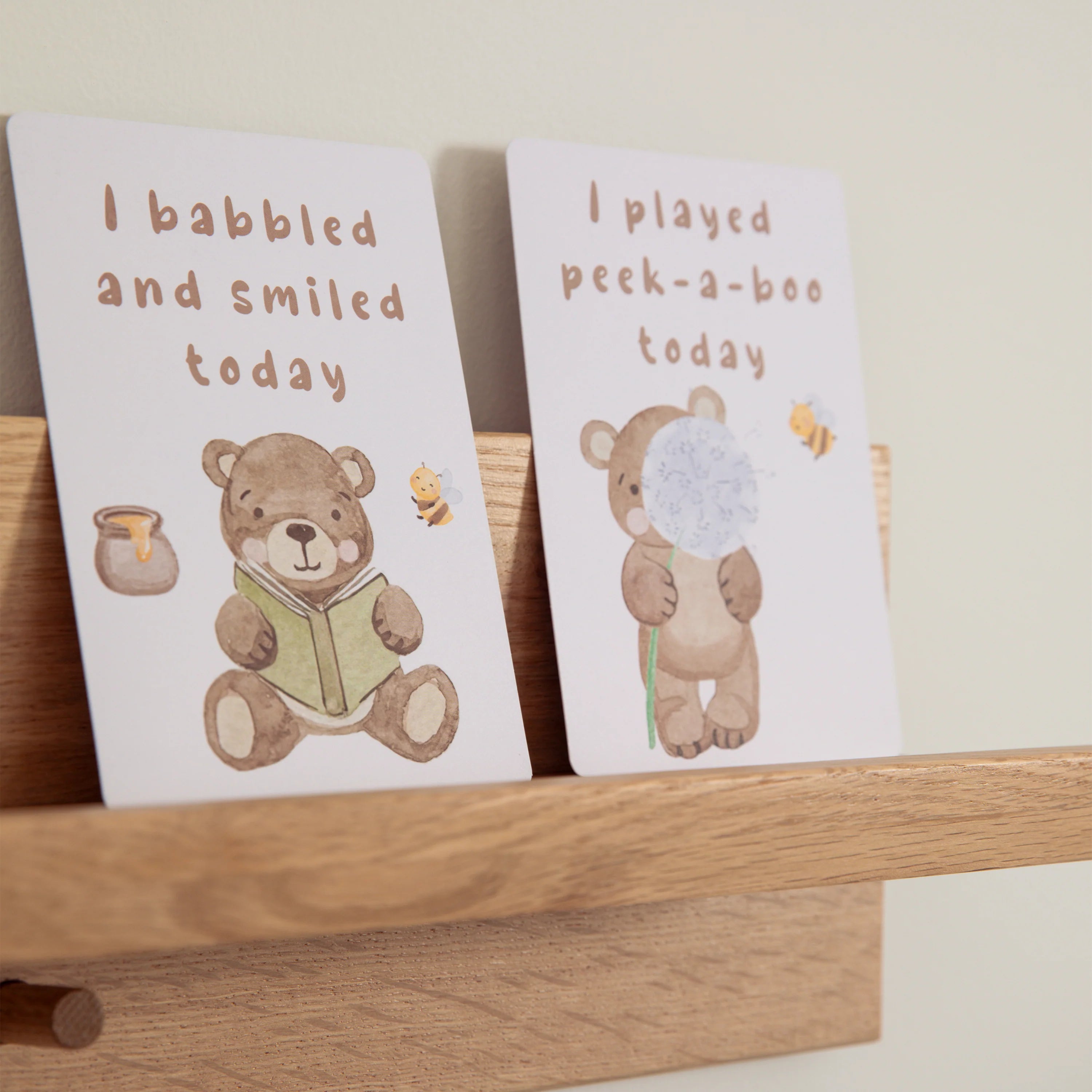 milestone cards by lively living to track babies age and milestones. great for photos and theme is cuddly bear. card pictured reads i babbled and smiled today, i played peek a boo today