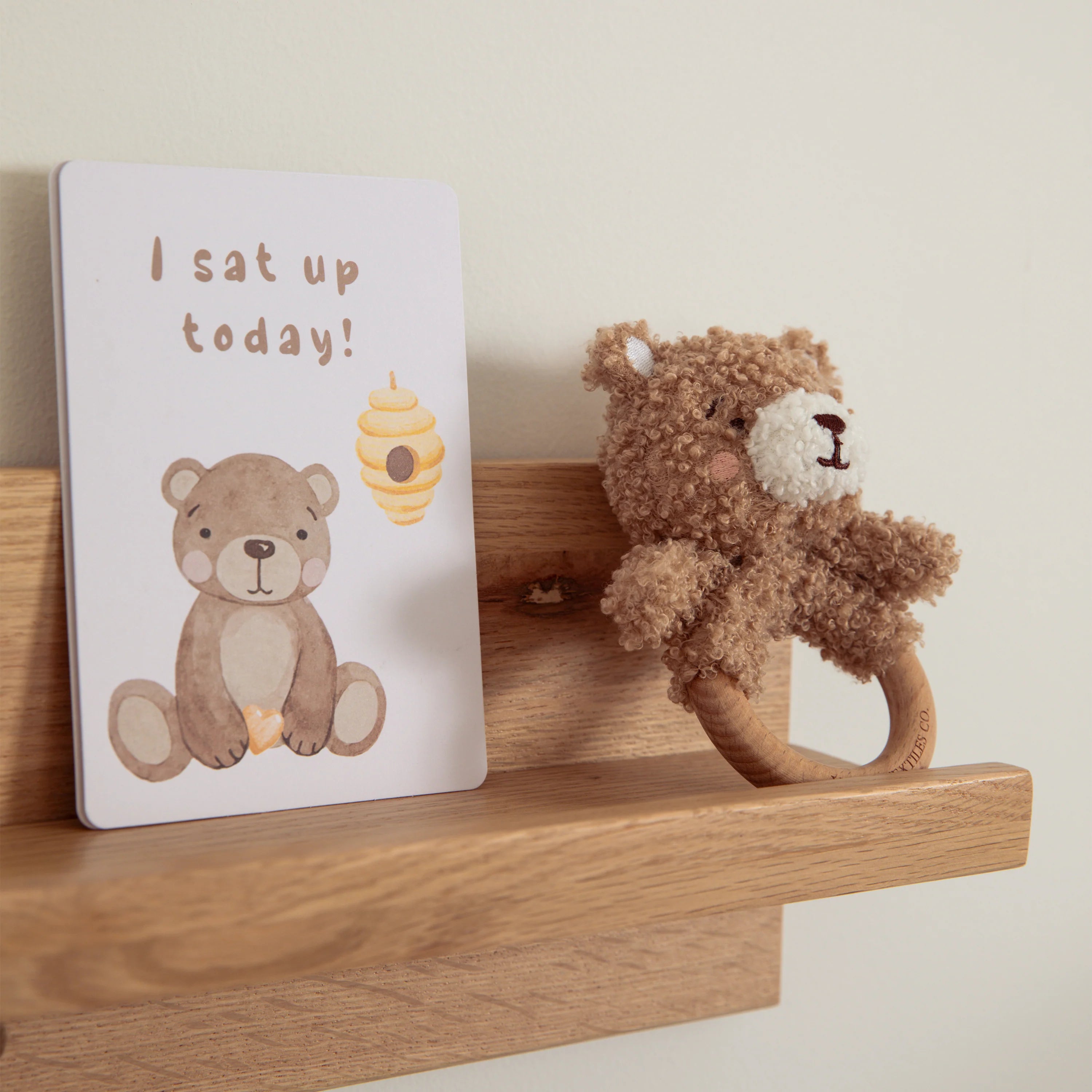 milestone cards by lively living to track babies age and milestones. great for photos and theme is cuddly bear. card pictured reads i sat up today