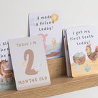milestone cards by lively living to track babies age and milestones. great for photos and theme is tractor ride. card pictured reads i made a friend today, i got my first tooth today, today i'm 2 months old