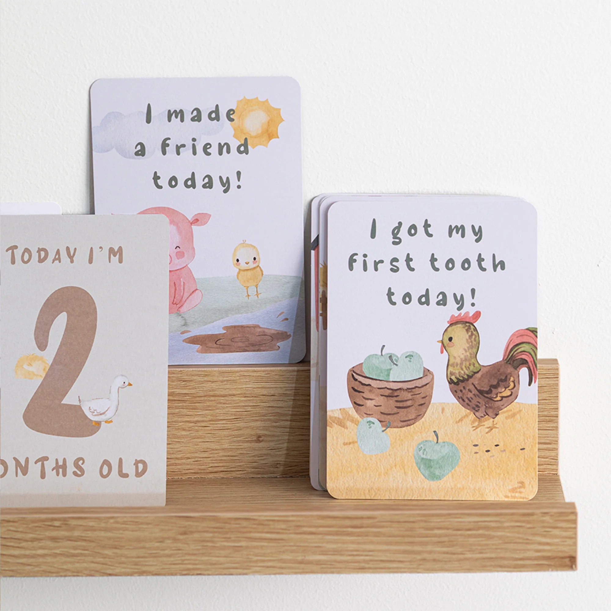 milestone cards by lively living to track babies age and milestones. great for photos and theme is tractor ride. card pictured reads today i'm 2 months old, i made a friend today, i got my first tooth today