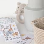 photoshoot of milestone cards by lively living to track babies age and milestones. great for photos and theme is wild safari. card pictured reads hello world, my first outing
