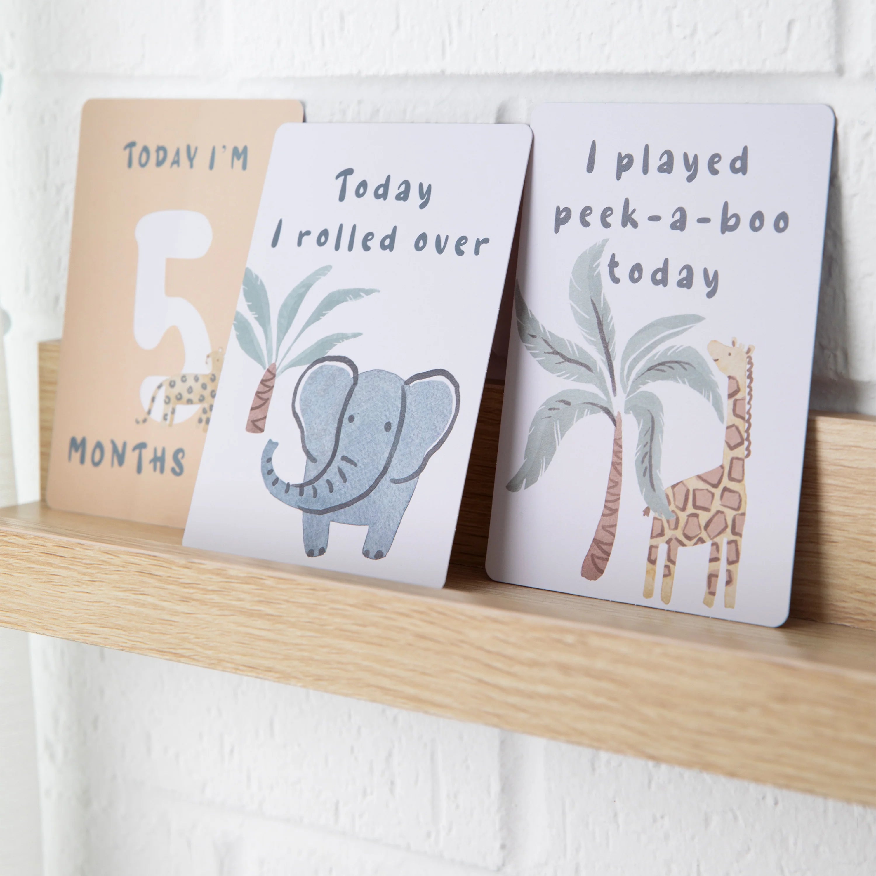 milestone cards by lively living to track babies age and milestones. great for photos and theme is wild safari. card pictured reads today i'm 5 months old, today i rolled over, i played peek a boo today