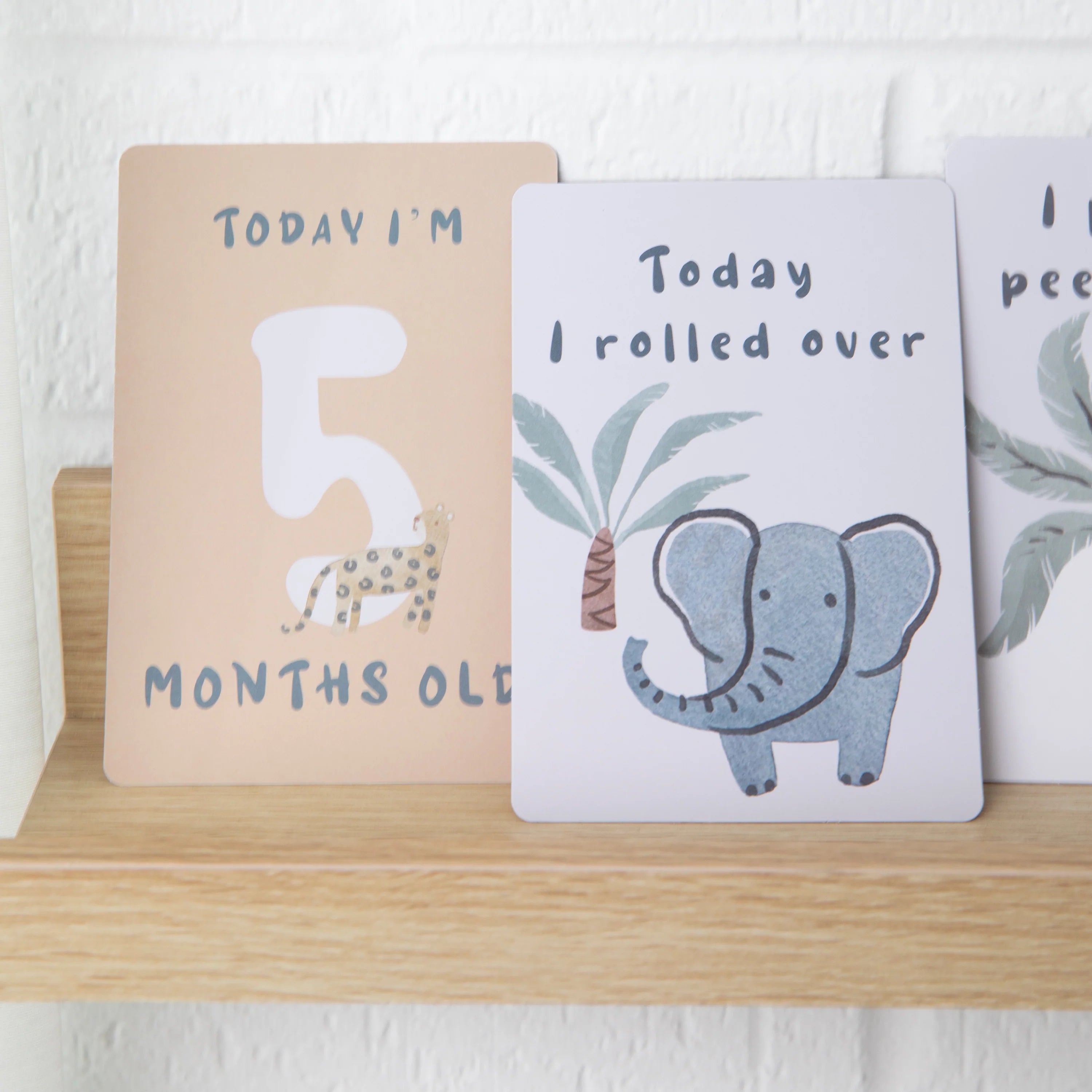 milestone cards by lively living to track babies age and milestones. great for photos and theme is wild safari. card pictured reads today i'm 5 months old, today i rolled over
