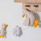 close up of nursery bunting to hang in room and display cute art decor. theme is goosey goosey with flowers and geese