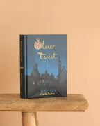  Oliver Twist collector’s edition hardcover by Charles Dickens with navy blue illustrated cover, gold foil title, cloth-bound finish.