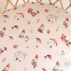 Gnomes print organic cotton bassinet sheet laid flat showing playful woodland gnomes and nature illustrations on soft jersey fabric