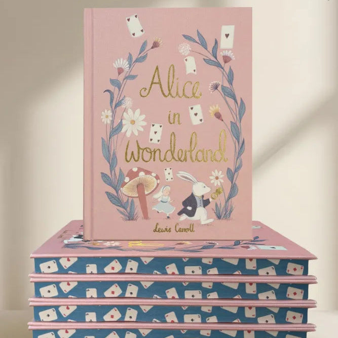 edges Alice in Wonderland collector’s edition hardback book with blush pink illustrated cover, gold foil lettering and sprayed heart cards page edges by Lewis Carroll. wordsworth collectors limited edition