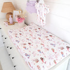 Mermaid organic change pad cover styled on a baby change mat in a whimsical under the sea nursery setting