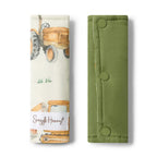 Snuggle Hunny Diggers and Tractors pram strap covers folded showing organic cotton fabric with construction vehicle print