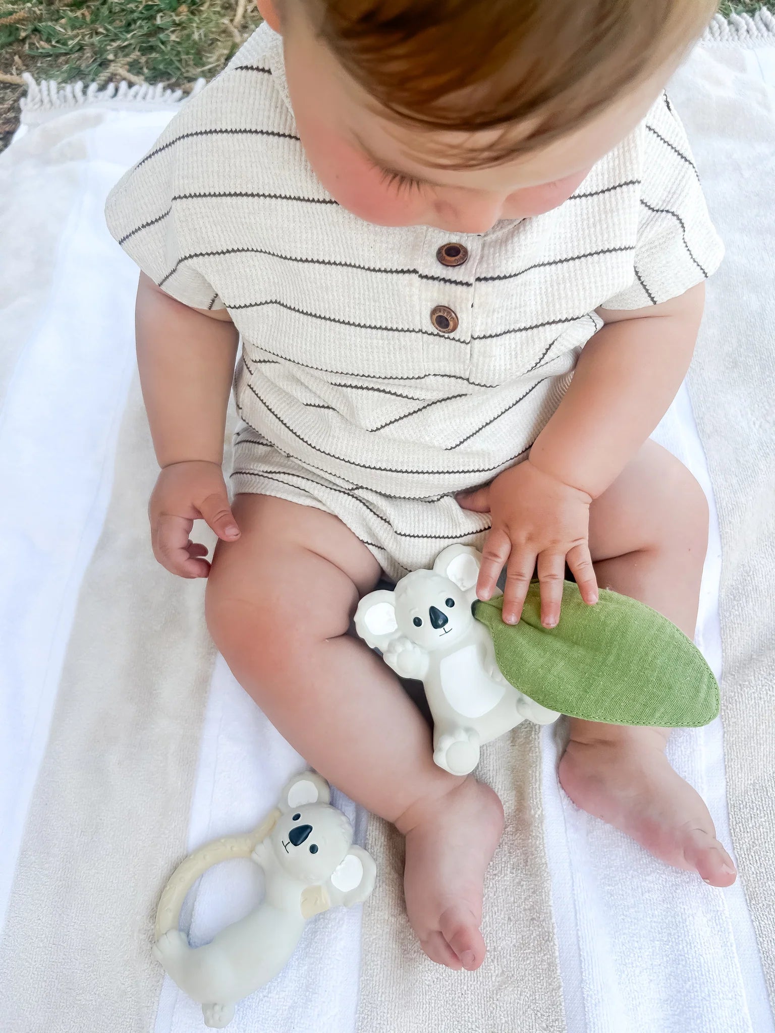 Baby holding Winnie Parkes Banks the Koala Rattle Scrunch toy
