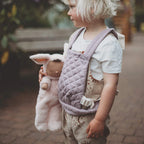 Child holding Pip Bunny Cozy Dinkum doll Olli Ella