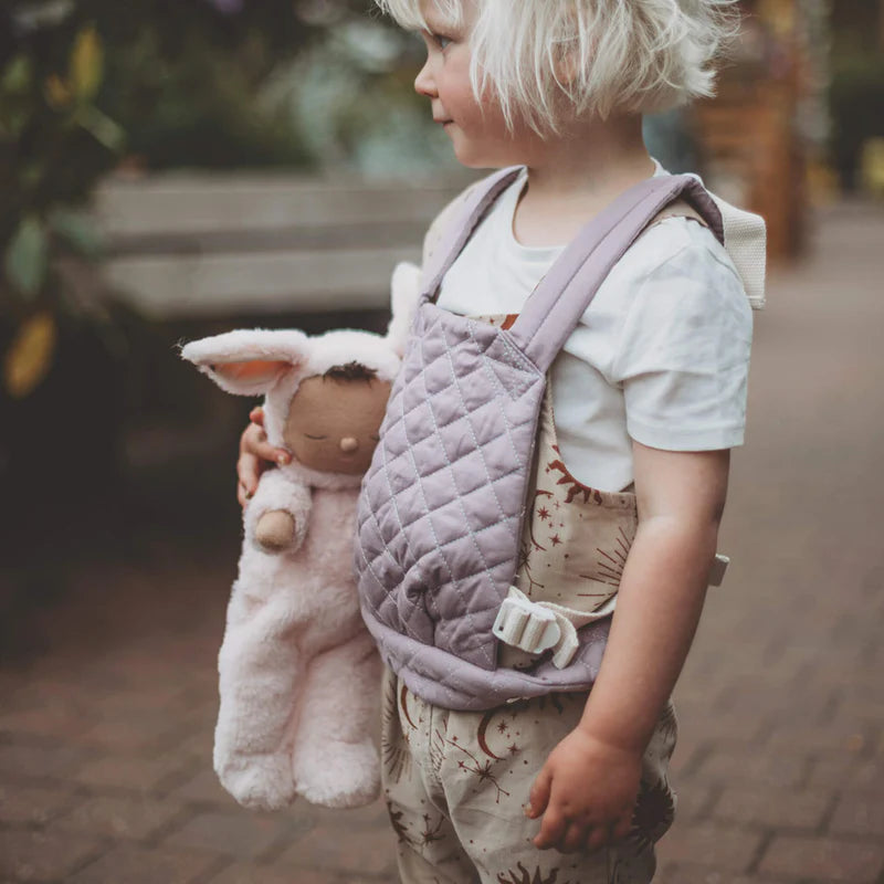 Child holding Pip Bunny Cozy Dinkum doll Olli Ella