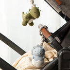 Living Textiles dinosaur stroller toys attached to a baby pram for on-the-go play